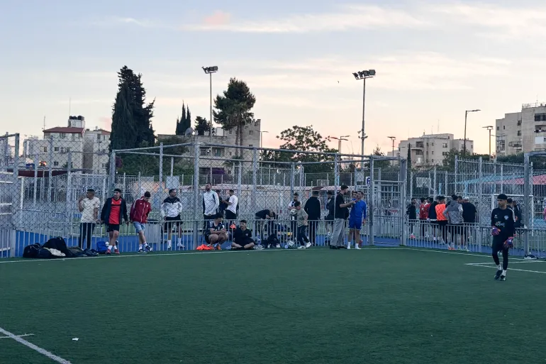 Scatto al tramonto di varie persone, inclusi i giocatori della squadra nazionale, in attesa di giocare durante il torneo Eid.