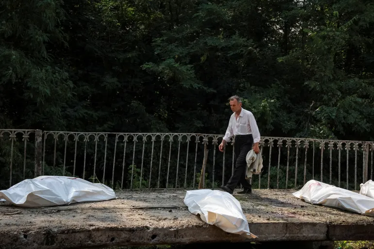 Un uomo cammina vicino ai corpi dei residenti uccisi in sacchi per cadaveri in una stazione ferroviaria, luogo di un attacco aereo russo, nel mezzo dell'attacco russo all'Ucraina, nella regione di Kiev, Ucraina, il 5 agosto 2026. IMMAGINI TPX REUTERS/Stringer DEL GIORNO