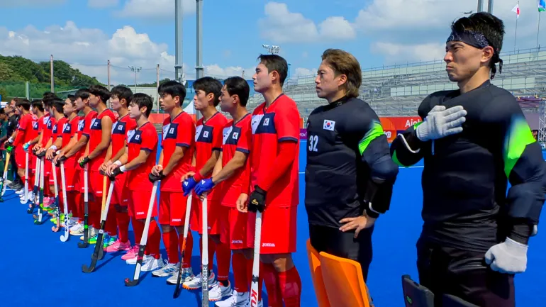 In questa immagine tratta da un video, i giocatori sudcoreani di hockey su prato reagiscono mentre viene suonato l'inno nazionale nordcoreano prima della partita contro il Bangladesh ai Giochi asiatici